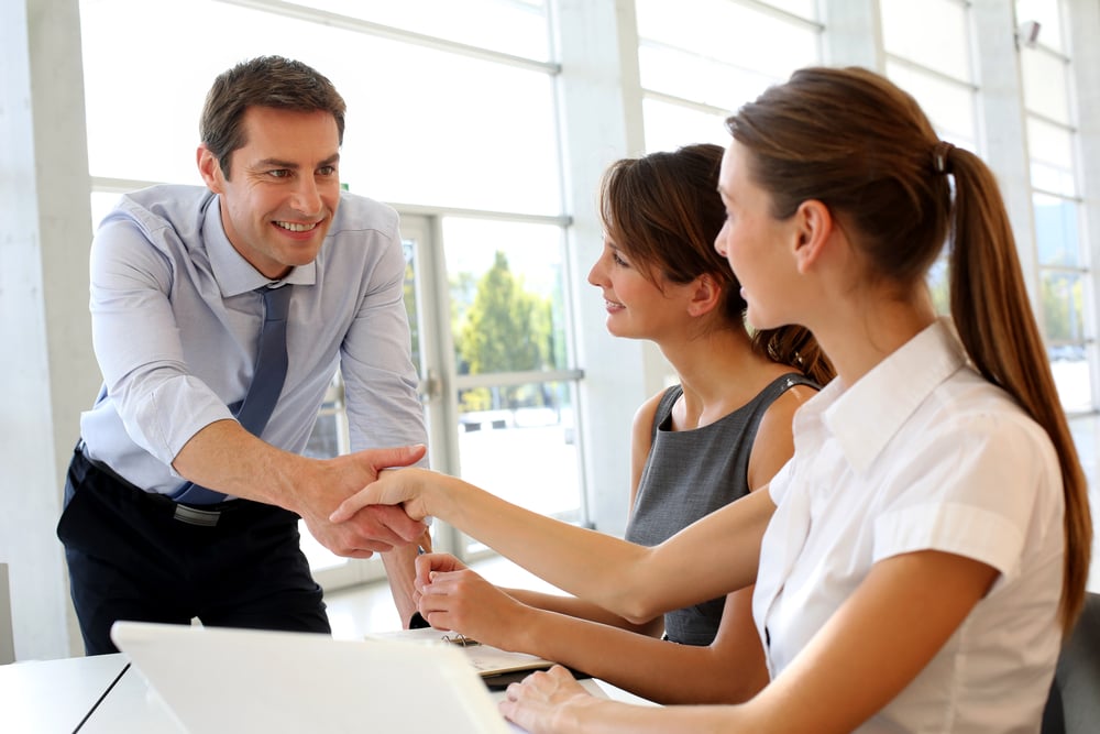 Salesman shaking hands to clients